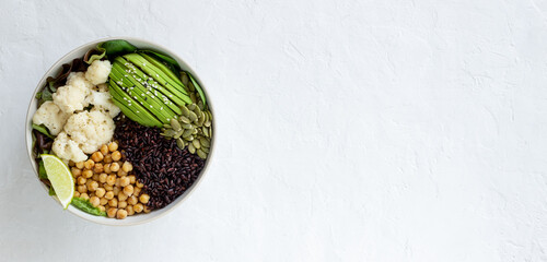 Bowl with avocado, black rice, chickpeas, cabbage, spinach and salad. Healthy eating. Vegetarian food.