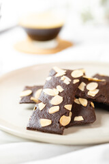 crunchy brittle brownie crisps crackers set on white cafe table.