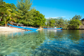 Boats on the beach of the small island of Poyalisa which is part of the Togian archipelago on Sulawesi. The Togian Islands in the Gulf of Tomini are a paradise for divers and snorkelers