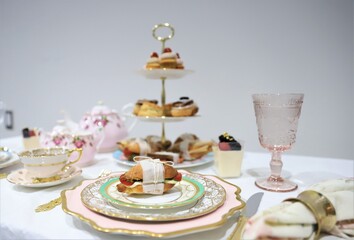 Table set up for tea party, focus on sandwich on the vintage plate