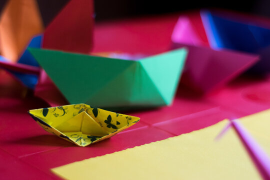 different sized origami boats on a table