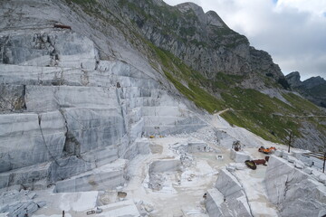 Fototapeta na wymiar White marble quarries on the Apuan Alps in Tuscany.Quarries near the Passo della Focolaccia with stepped mountain cut. Alpi Apuane, near Carrara, Italy. 