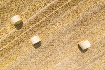 Looking straight down at a grain field with bales of straw 