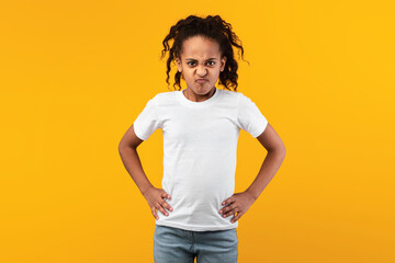 Angry young black girl standing with hands on hips