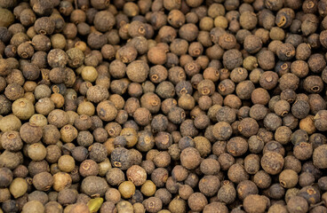Large pile of allspice peas. Food background