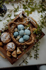 Orthodox Easter. Easter eggs and cakes top view. chicken eggs painted blue. chicken and quail eggs.