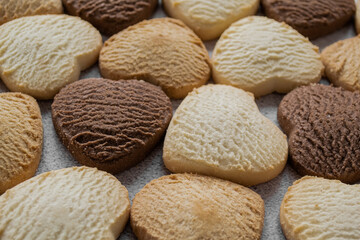 Lots of colorful heart-shaped cookies. Bakery, homemade. Food romantic background
