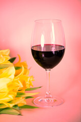 Wine glass with tulips, pink background, invitation card