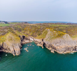 An aerial view from sea into an isolated rocky cove on the Pembrokeshire coast near to Tenby, South Wales in springtime