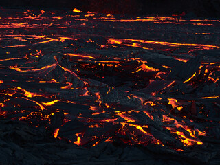 Stunning closeup view of glowing lava flow at eruption site of volcano in Geldingadalir valley near...