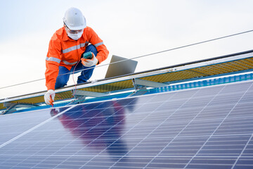 Male Engineer Industrial Technician Inspect Solar Panel Electricity With digital insulation tester At industrial plants that install solar panels using solar energy