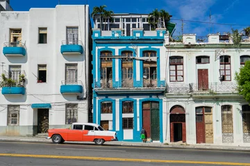 Zelfklevend Fotobehang A classic car driving along the streets of Havana, Cuba. © David