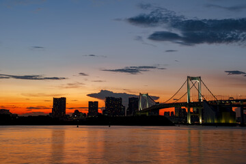 Tokyo skylines with Rainbow bridge at sunset. Japan.