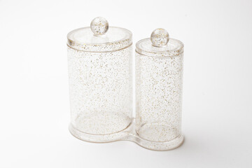 transparent jars with sequins isolated on white background