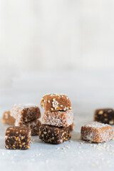 Stack of handmade vegan desserts made of dried fruits. Healthy raw vegetarian candies without sugar.