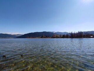 Crystal clear lake with mountainous backdrop