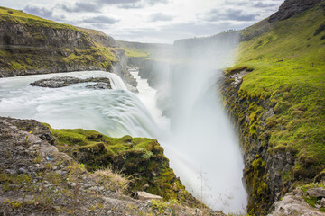 Obraz premium Gullfoss falls with long exposure, waterfall with summer wet colors in Iceland