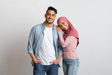 Naklejka premium Portrait Of Young Affectionate Arabic Family, Millennial Man And Woman In Hijab