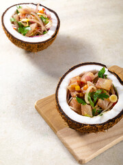 Ceviche dish - appetiser of fresh fish marinated in citrus with tropical fruits served in a Coconut Bowls