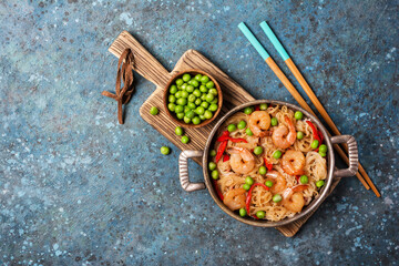 Traditional dish of Asian cuisine. Rice vermicelli with shrimps and green peas