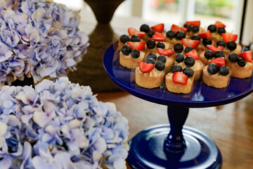 Blue sideboard with strawberry jam. With blue flowers.