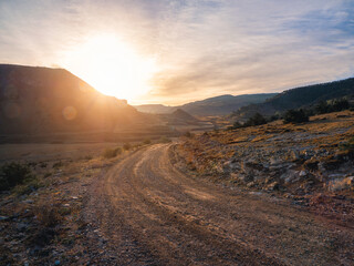 Morning dirt road through the mountain plateau. © sablinstanislav