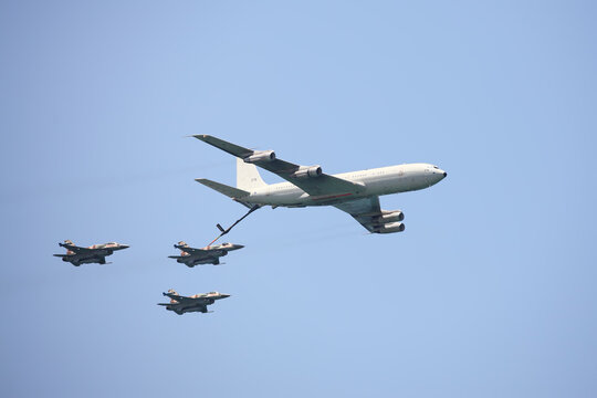 Boeing 707 Plane Is Refueling F-16 Airplanes. Aerial Refueling Extend The Range Of Strategic Bombers.