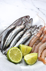 Anchovies, prawns and raw whiting prepared for frying.