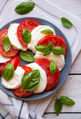 Caprese salad with mozzarella cheese, tomatoes and basil. Typical Italian cuisine