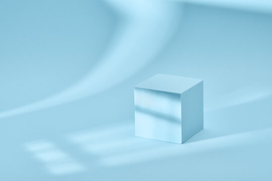 Blue background for product presentation with shadows and light. Empty cubic podium. Mockup.