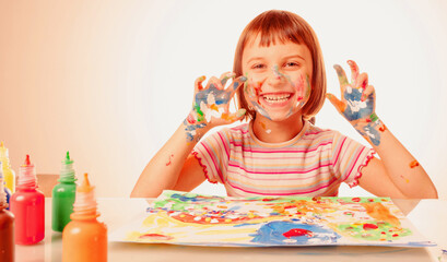 Art and fun leisure time concept. Funny portrait of huppy beautiful young child girl with colorful...