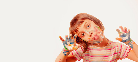 Funny portrait of huppy beautiful young child girl with colorful painted face and hands. Free copy space for design or text.