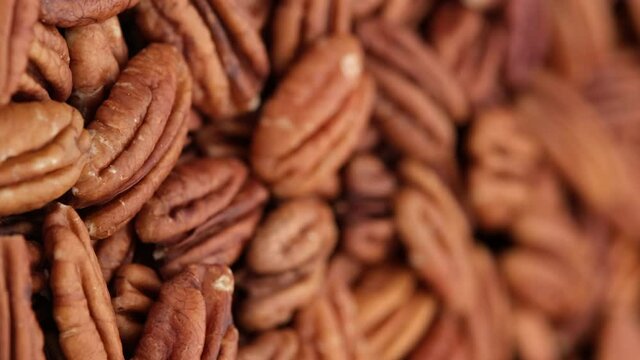 raw pecan nuts close up, rotation. Healthy food concept. Vertical video. 4K UHD video
