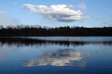 Beautiful scenery with reflection of cloud in lake in evening light