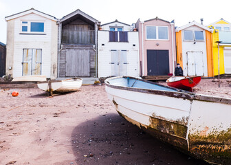 Fototapeta na wymiar Boats Moored At Low Tide On The Back Beach At Teignmouth, Devon