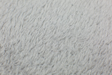 Grey cotton towel or carpet.fluffy texture background. Close up, macro photo. Soft focus image.
