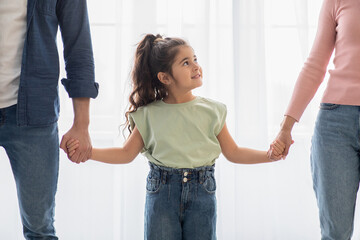 Adorable Cute Little Arab Girl Holding Hands With Parents At Home, Closeup
