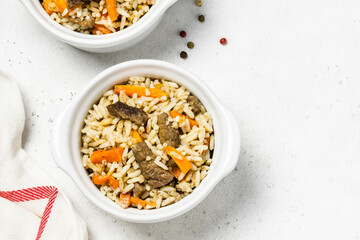 Oven baked, spicy rice and meat in pots. Space for text, top view.