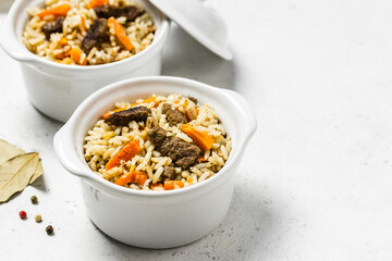 Rice pilaf with orzo and meat in pots. Space for text.