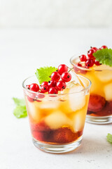 Red currants, summer berry iced tea in glasses. Space fot text.