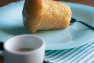 Famous Espresso and Neapolitan baba on a blue plate for a sweet snack 
