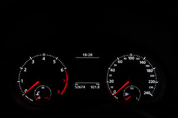 Car speedometer dashboard lit up in the dark. Engine start, transportation gas tank gauge concepts