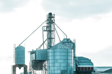 Silo tower for storing and protecting feed, grain or cement from exposure to water and air. Silo industry, manufacturing, storage tanks on agriculture industrial plant
