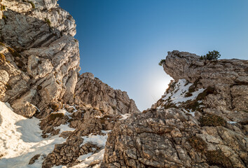 Top of the Chiemgau Kampenwand with a stunning view across the Bavarian Alps and mountain rocks at the foreground