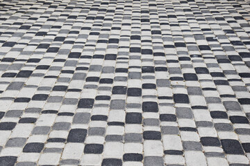 Fototapeta premium Squares of white, black and gray, lined with checkered cubic stone tiles. Abstract tile background pattern in white, black and gray colors. Background for inscriptions, place for text.