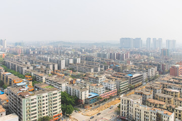 Fototapeta na wymiar Aerial cityscape skyline view of urban sprawl with air pollution and smog in Huadu District suburb of Baiyun Guangzhou, China.