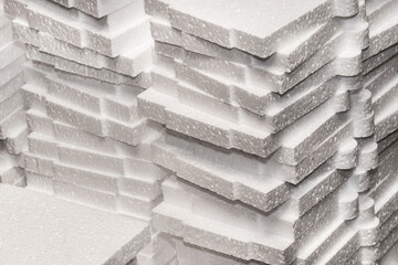 A pile of white polystyrene industrial foam material storage on warehouse