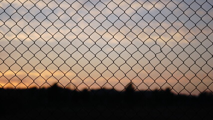 Fototapeta premium sunset sky through a grate