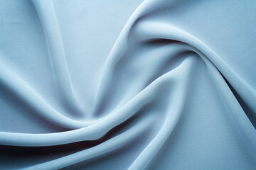 light blue fabric draped with swirl folds, textile background