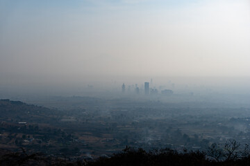 Fototapeta na wymiar City of Puebla, Mexico covered in fog and air pollution in the morning